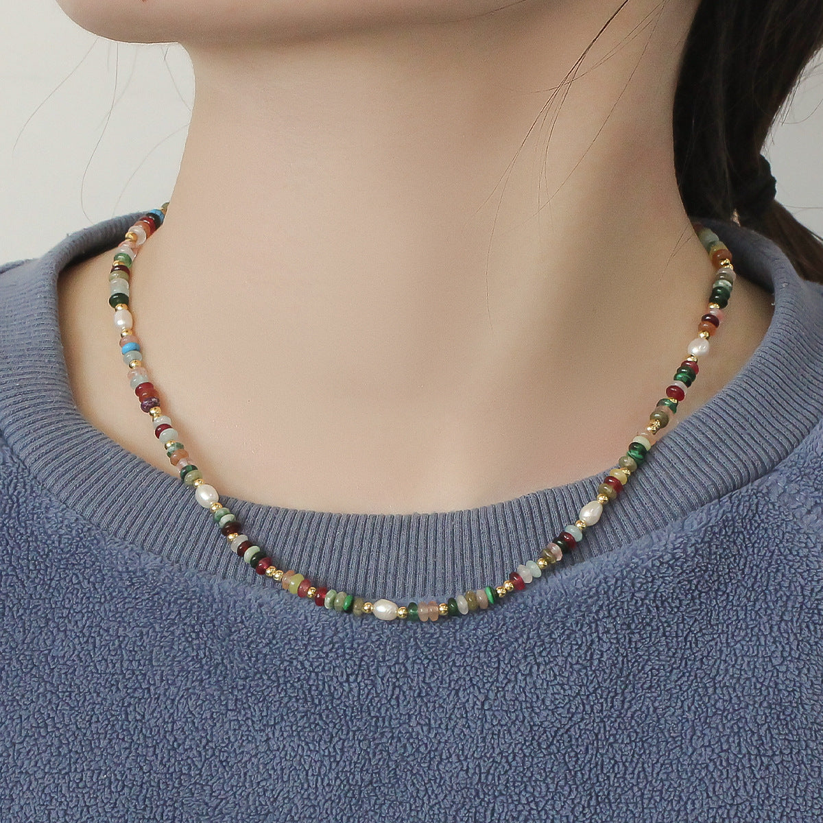 Colorful gemstone bead necklace worn on model for boho layered styling
